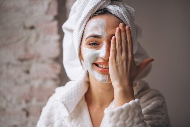 woman applying face cream on her face