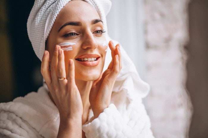 women applying face cream, imroz face cream