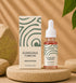 Kumkuma Nabhi Oil packaging with dropper bottle on a natural background
